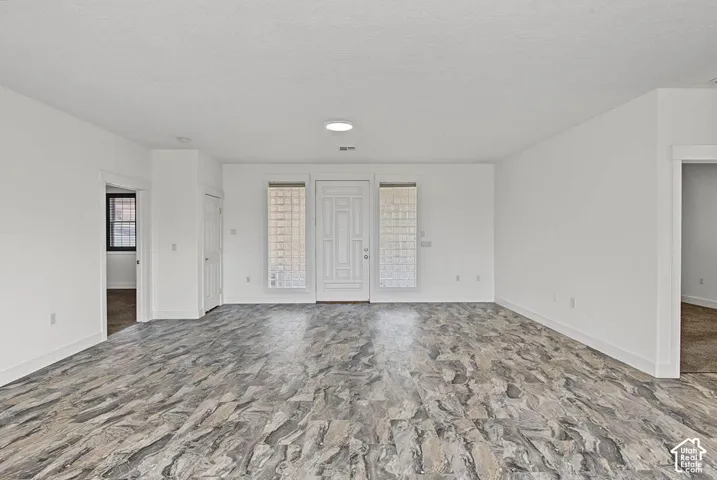 Entry with a white paneled door, sidelight windows, and a flush-mount ceiling light