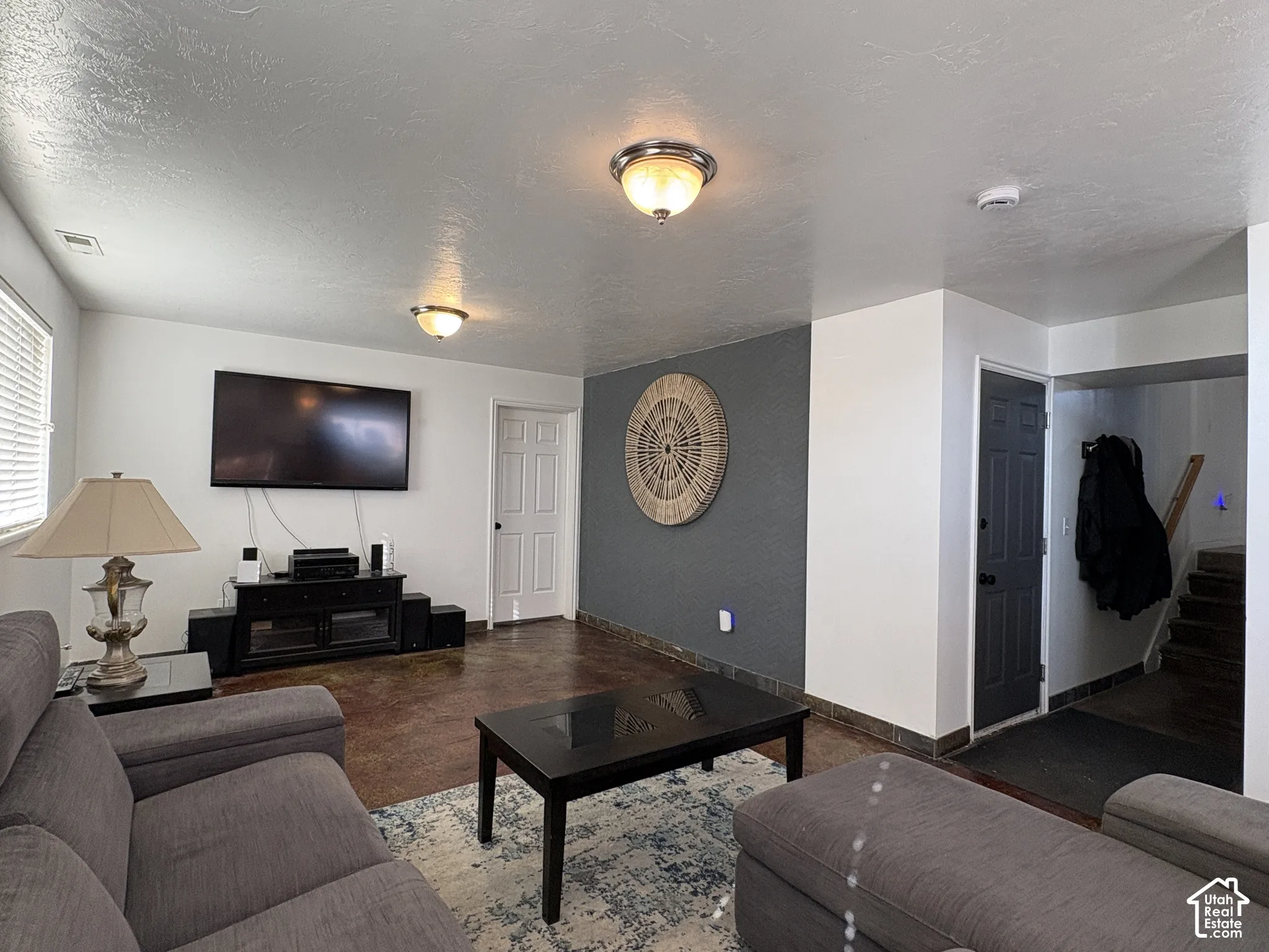 Family/tv room with stained concrete flooring