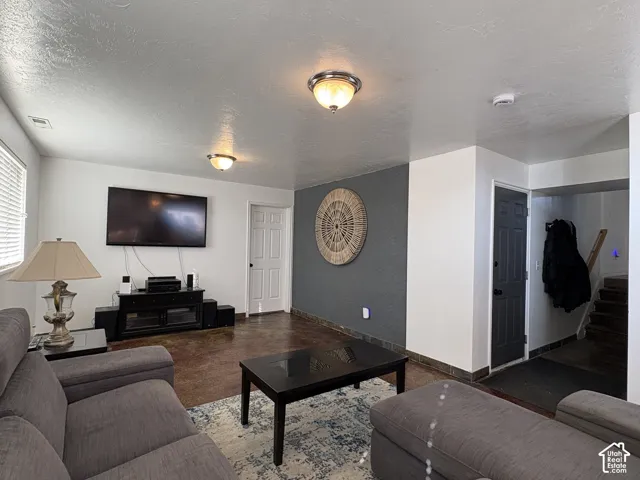 Family/tv room with stained concrete flooring