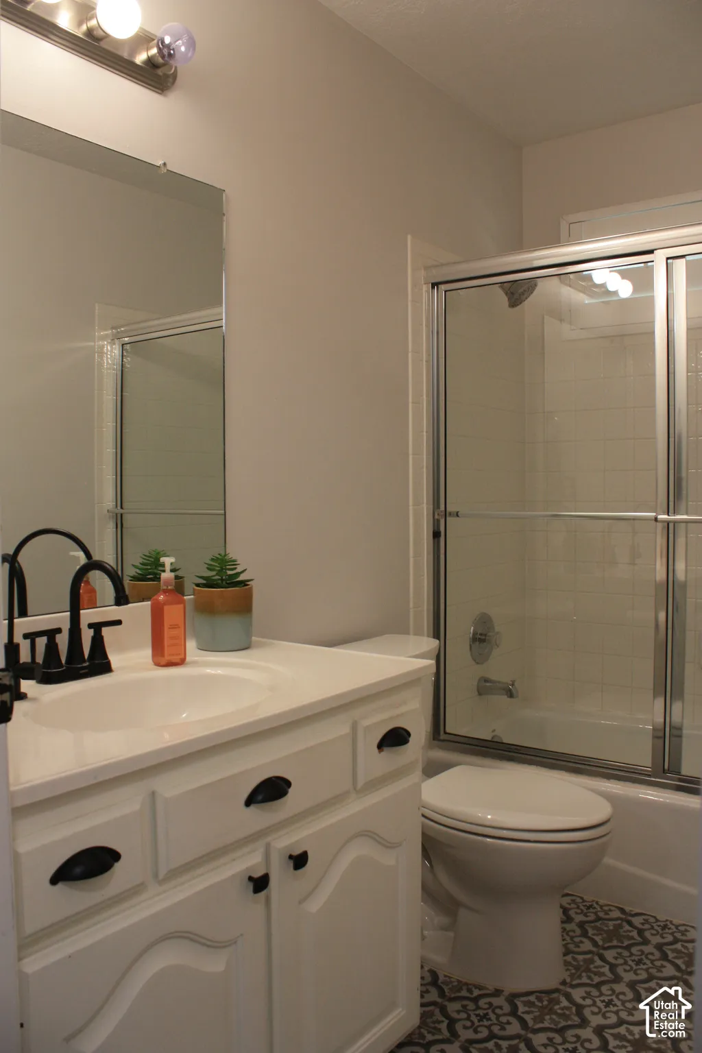White vanity with black hardware and an integrated sink