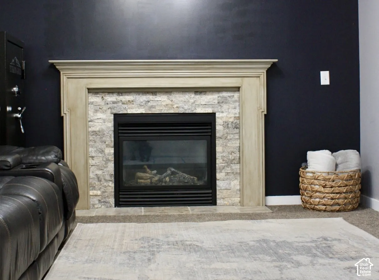 Fireplace featuring a stone tile surround, a built-in firebox, and a decorative mantel