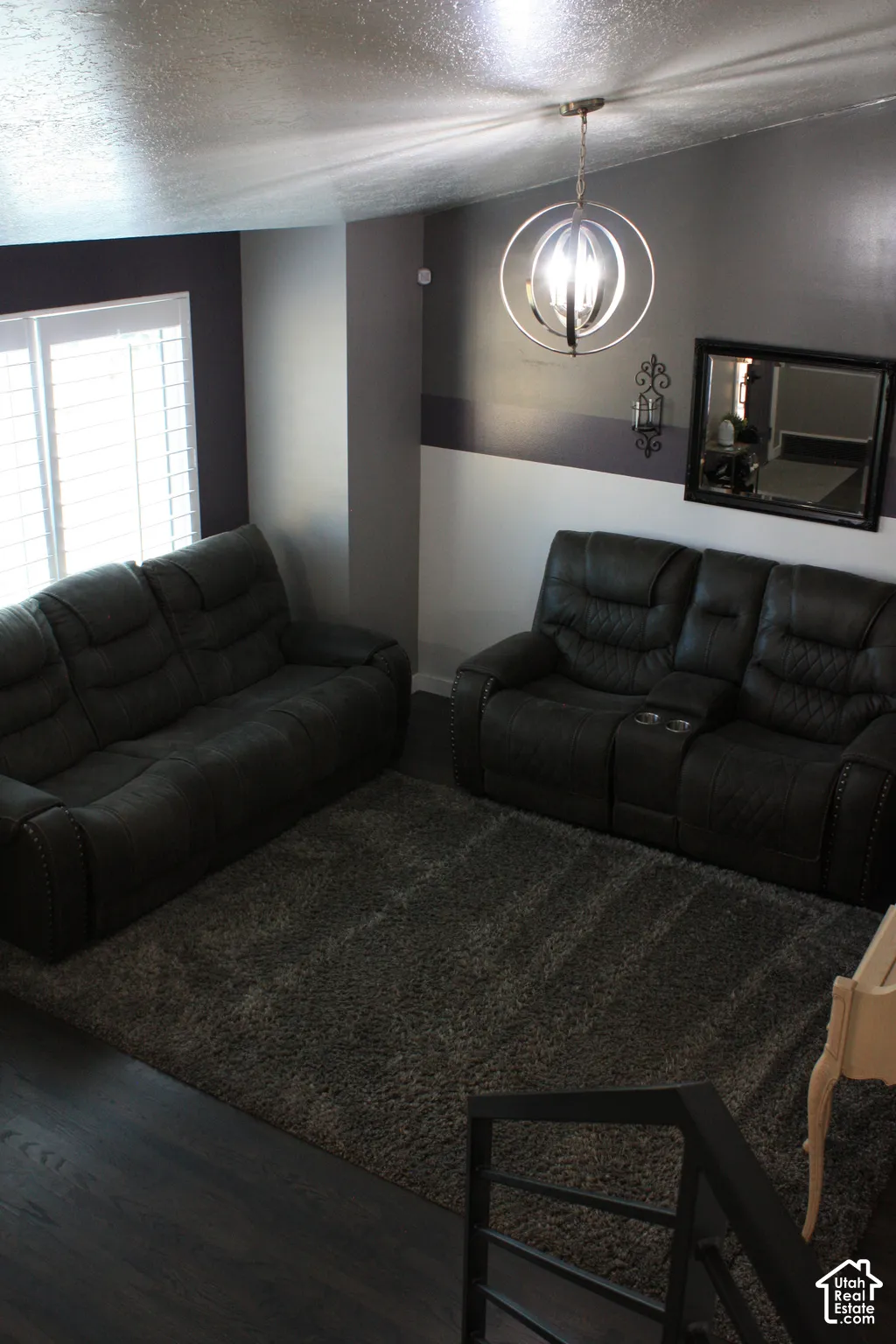 Dark wood-finish flooring with an area rug