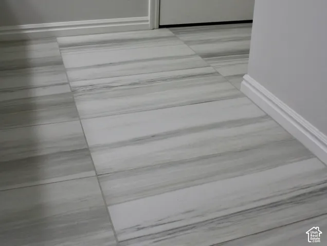 Wide-plank tile flooring with a linear grain pattern