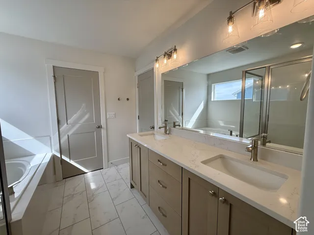 Dual vanity with light-toned cabinetry, integrated sinks, and polished hardware