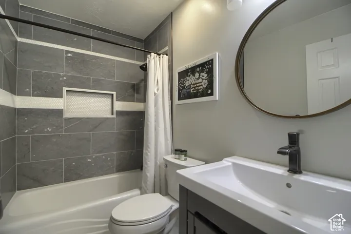 Shower-tub combination with gray tile surround and mosaic accent