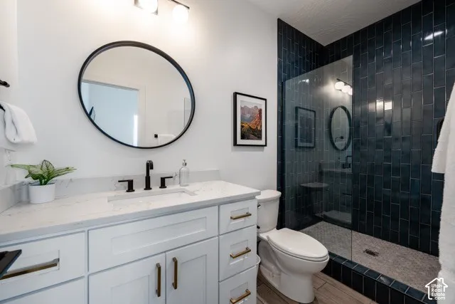 White vanity with a stone-finish countertop and integrated sink