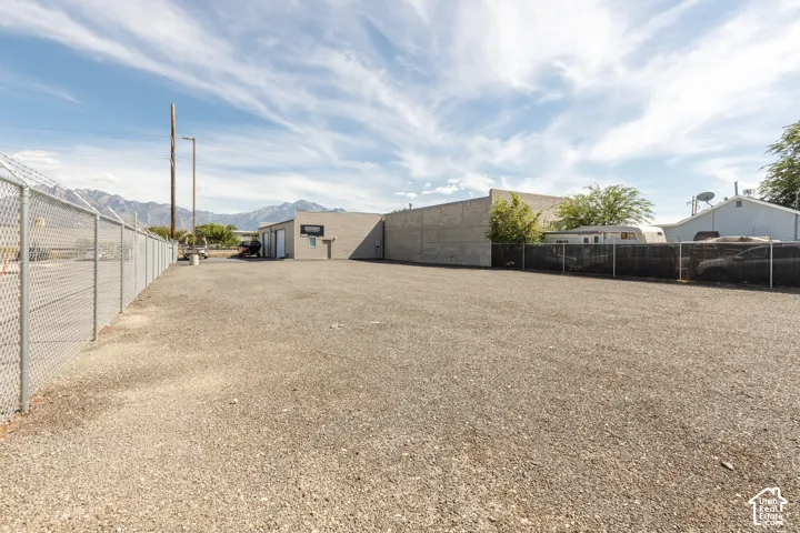 Expansive gravel lot with chain-link fencing