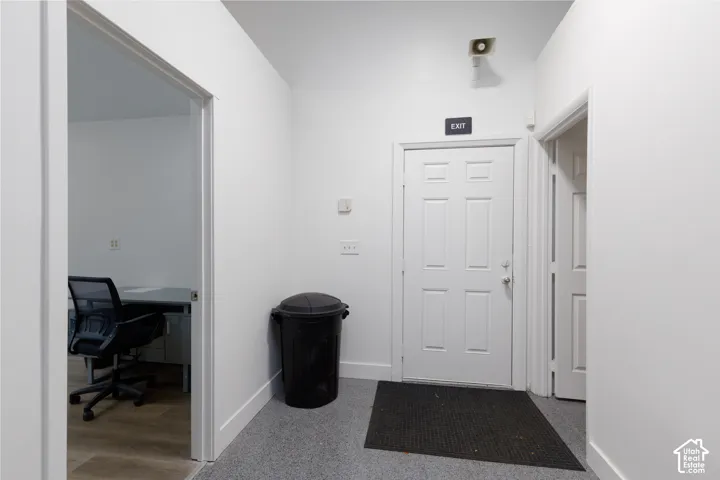 White interior walls with a white paneled door