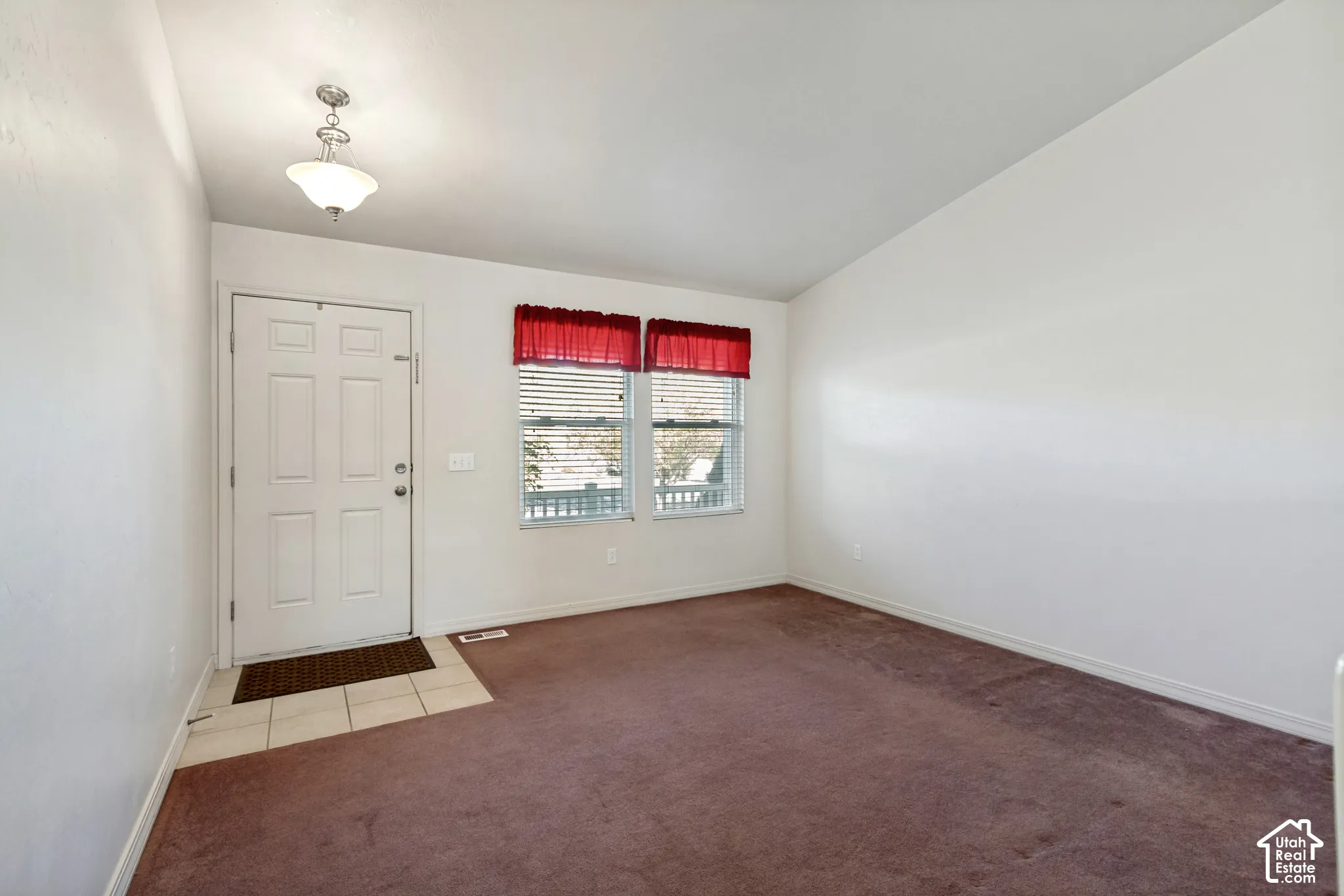 Entryway featuring a paneled door, ceramic tile flooring, and a ceiling-mounted light fixture