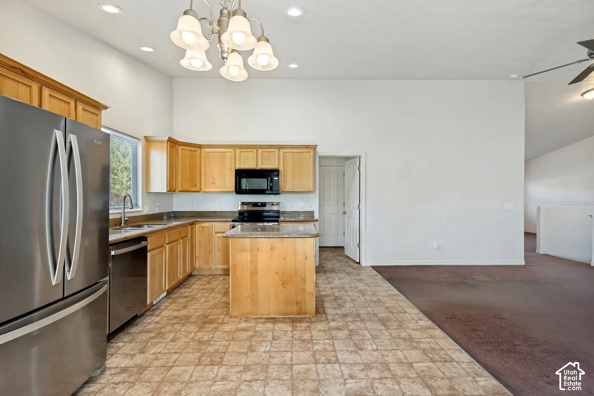 Kitchen featuring wood cabinetry, stainless steel appliances, a center island with countertop, and recessed lighting