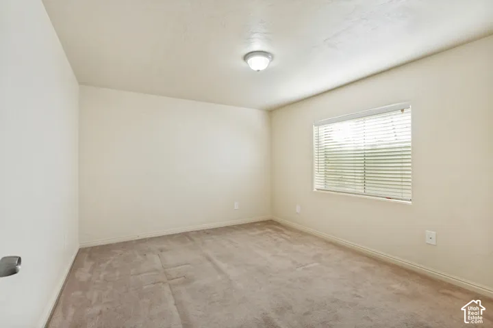 Neutral-toned walls complement the carpeted flooring