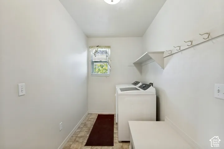 Tiled flooring, built-in shelving, and wall-mounted hooks
