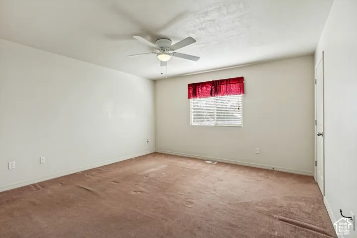 Recessed window with horizontal blinds, overhead ceiling fan with lighting fixture, and neutral wall tones