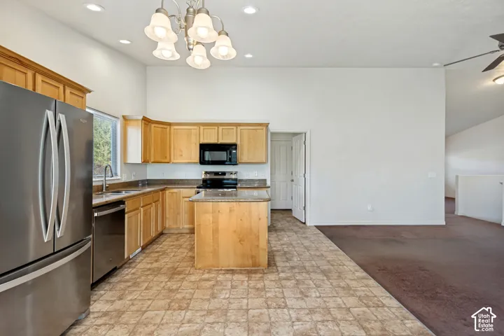 Kitchen featuring wood cabinetry, stainless steel appliances, a center island with countertop, and recessed lighting