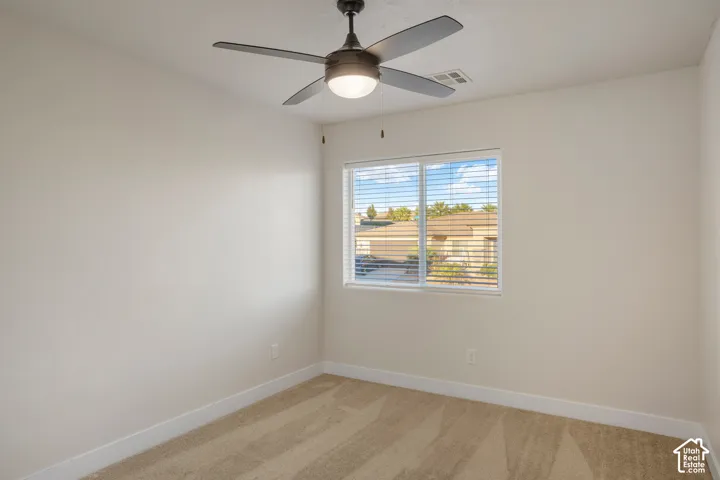 Bedroom 3. Recessed window with blinds, ceiling-mounted fan with integrated lighting, neutral wall finishes, and patterned carpeting