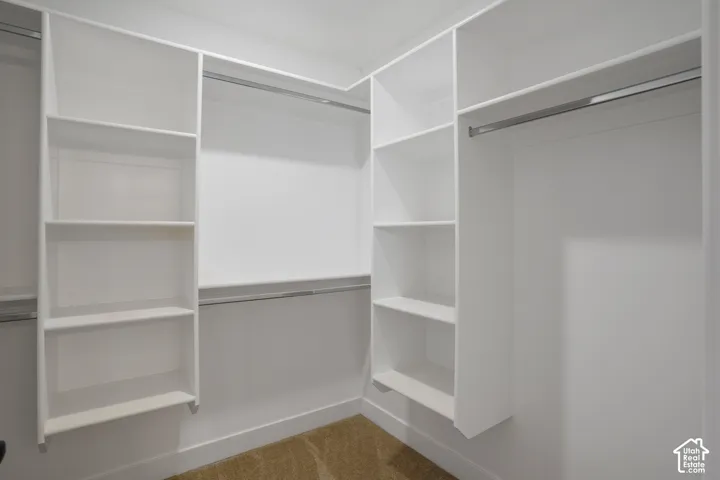 White built-in shelving, white walls, and built-in hanging rods