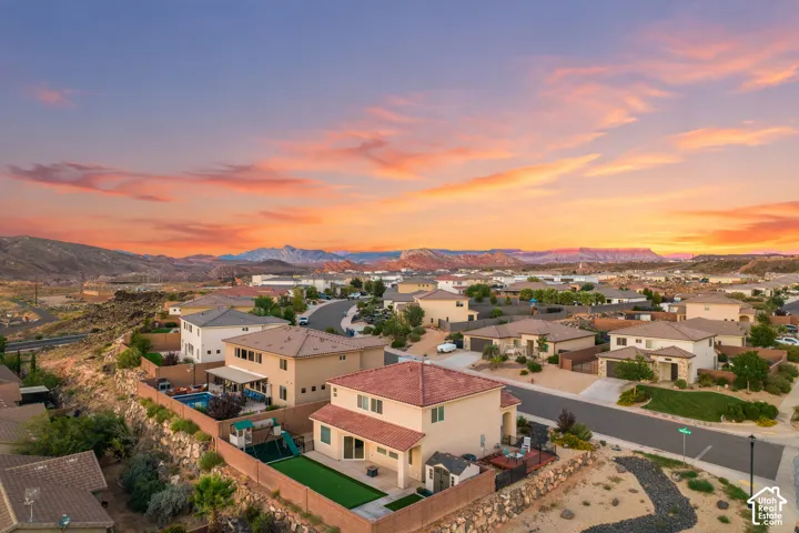 Neighborhood setting with residential structures and distant natural scenery
