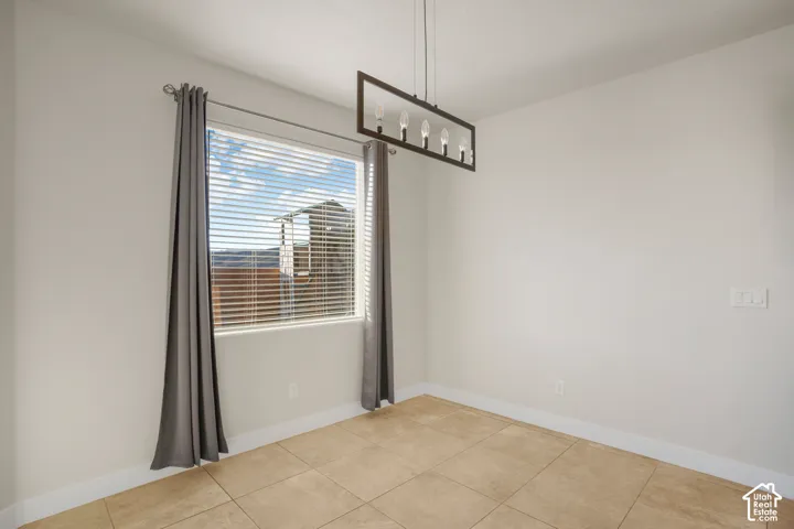 Recessed window with horizontal blinds, tiled flooring, and a rectangular ceiling light fixture