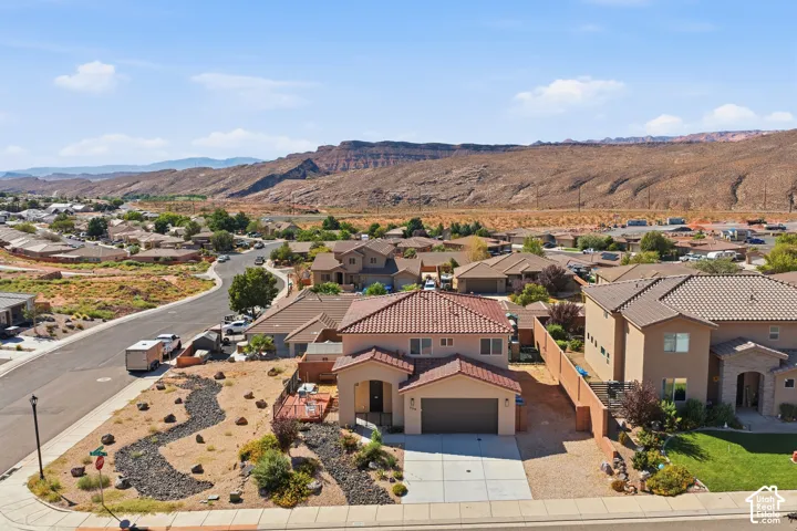 Two-story stucco exterior with a tile roof, an integrated garage, and a concrete driveway