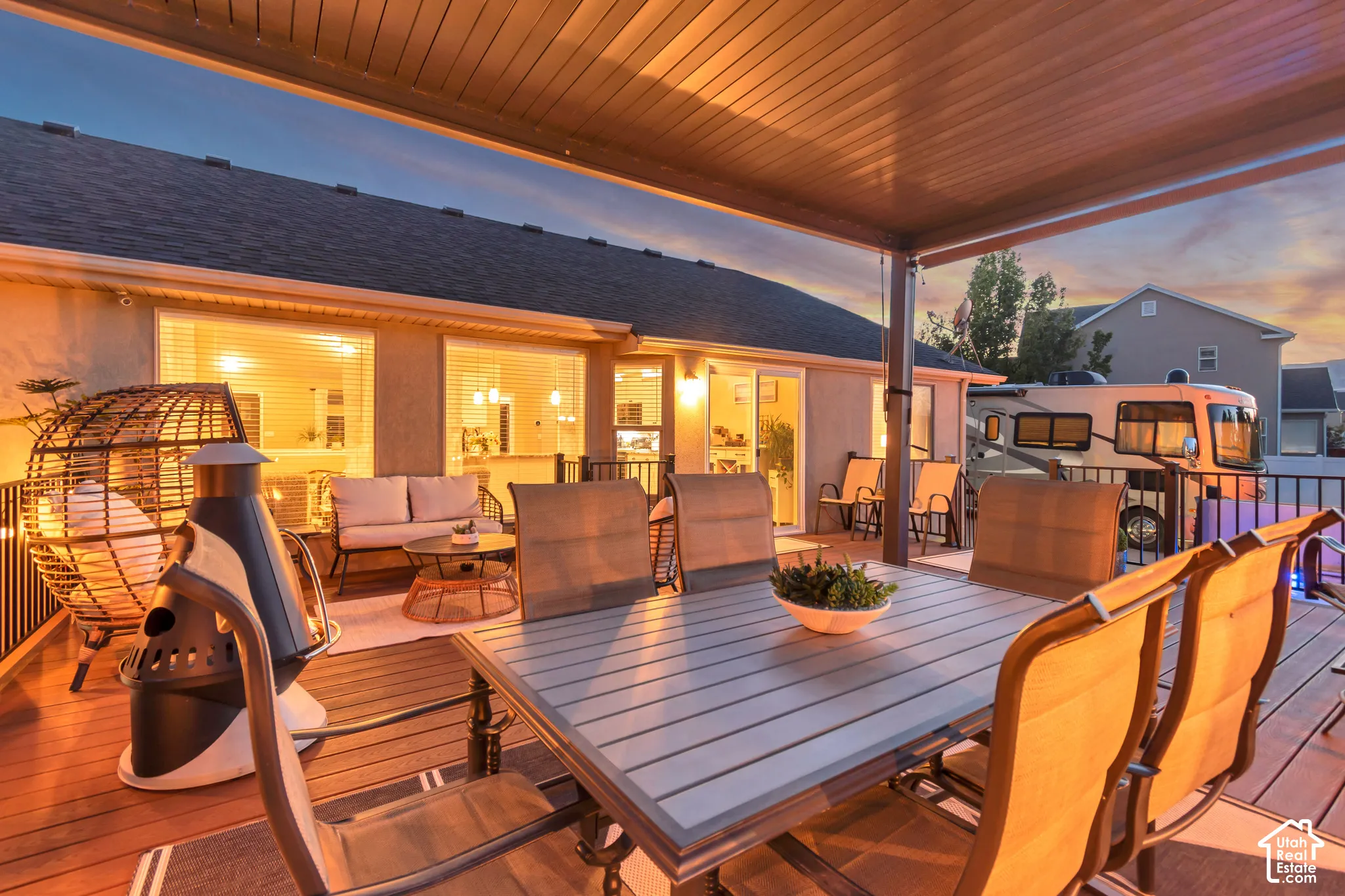 Expansive wood-finish deck with a solid covered patio structure, providing an outdoor living space