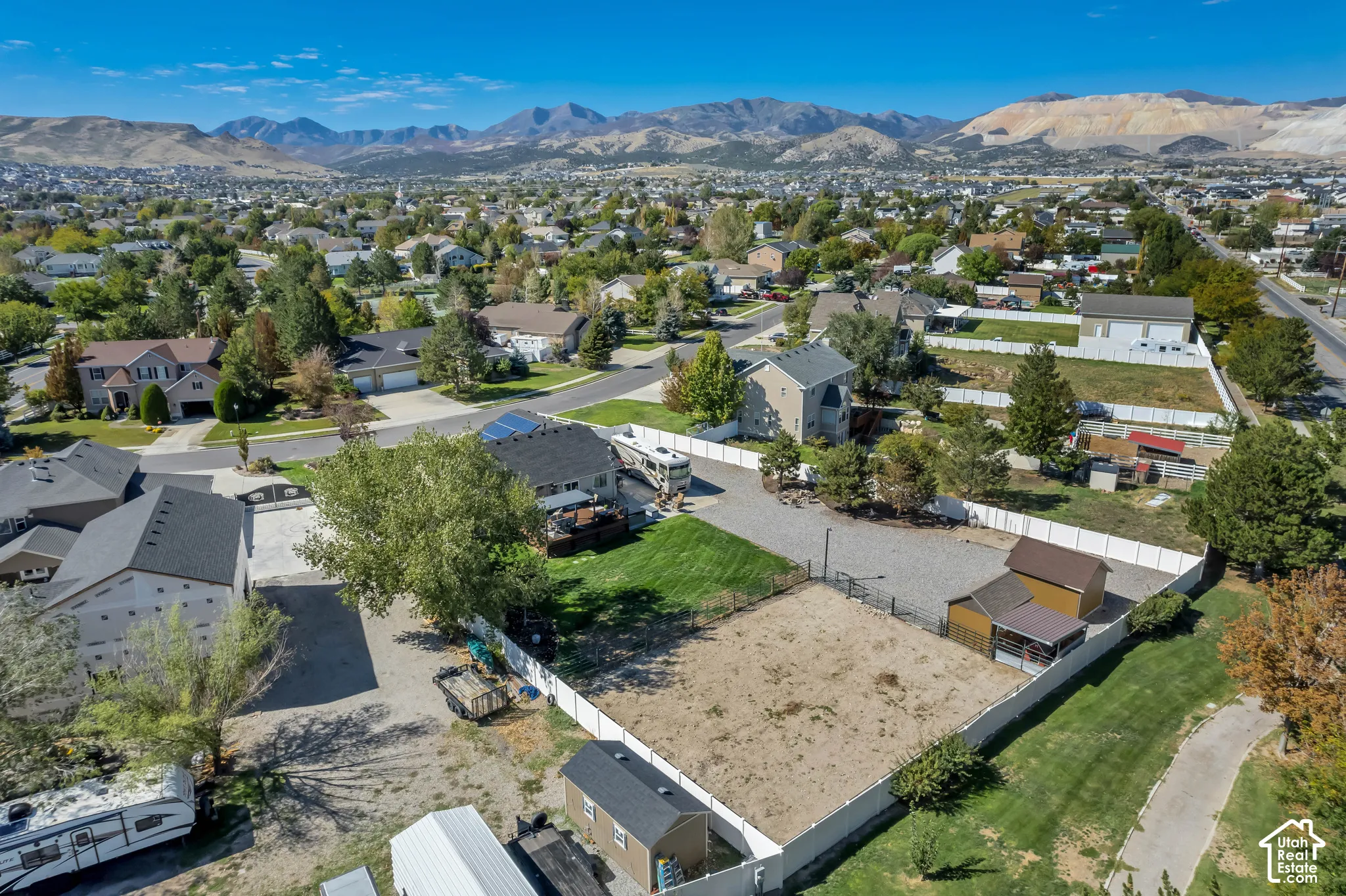 Expansive property featuring a gravel parking area, separate outbuilding, and mountain backdrop