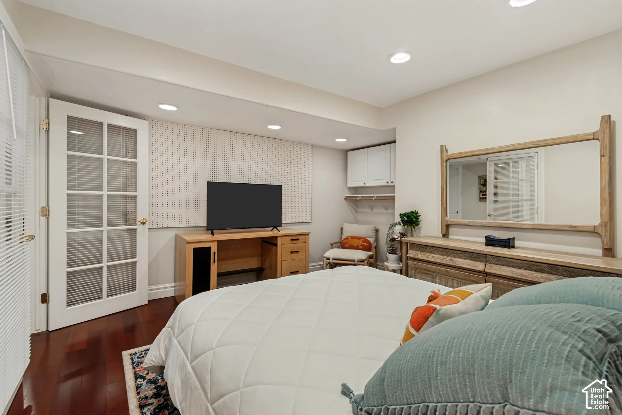 Hardwood-finish flooring, recessed lighting, and white French-style door with clear glass panels
