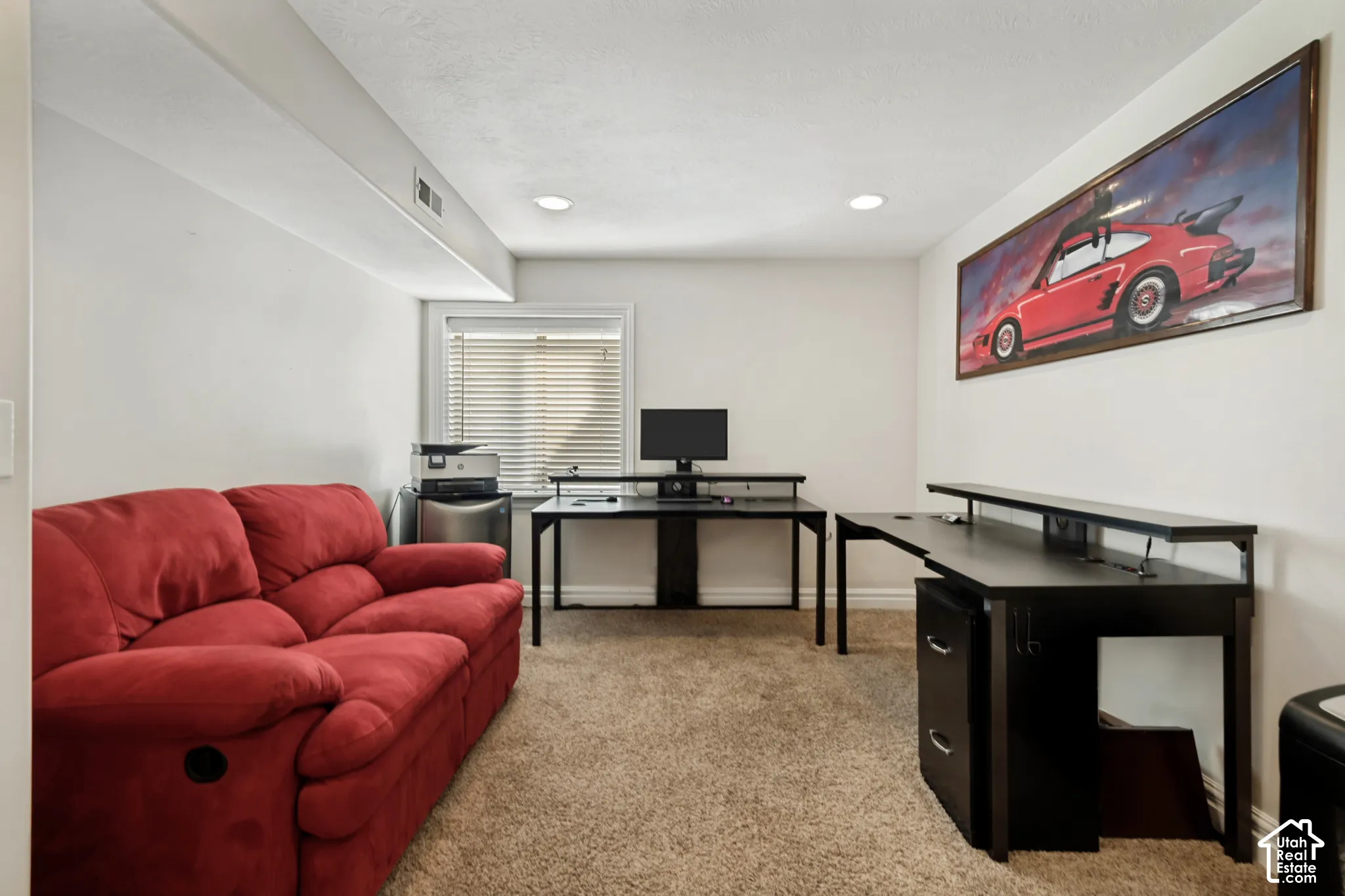 Recessed lighting, window with blinds, and neutral wall tones