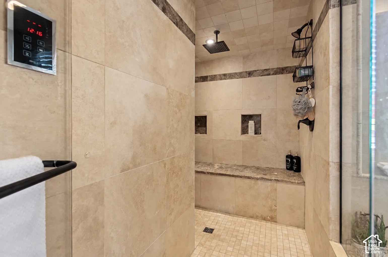 Walk-in shower with tiled walls and floor