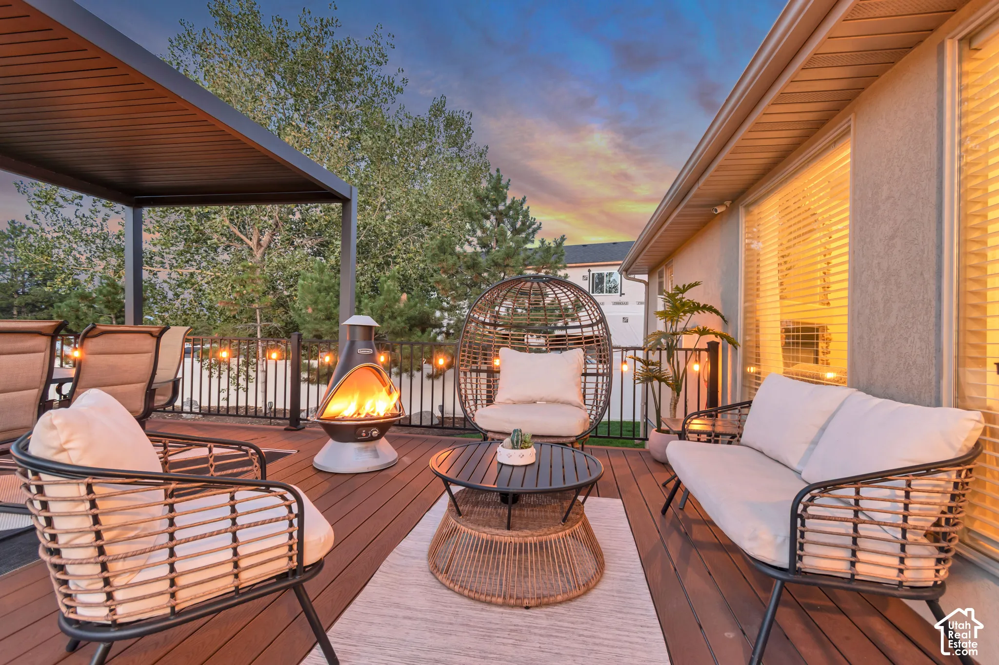 Expansive wood-finish deck featuring a modern pergola and black metal railing