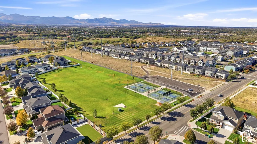 Expansive green space featuring multiple tennis courts and a surrounding residential community