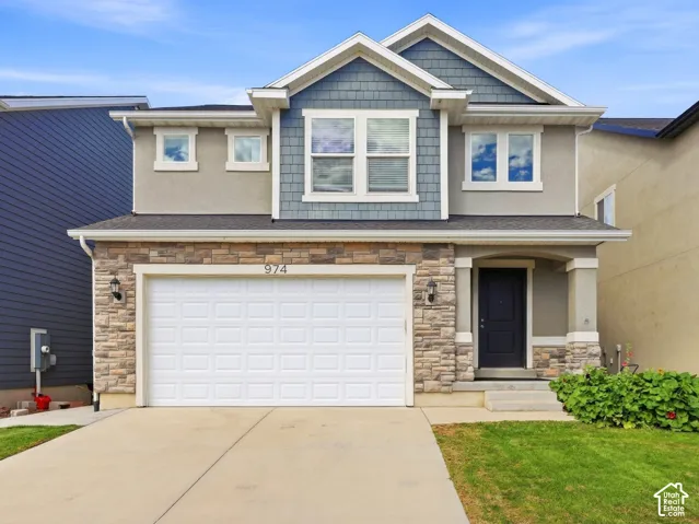 Multi-tone exterior featuring stone veneer, stucco, and horizontal siding