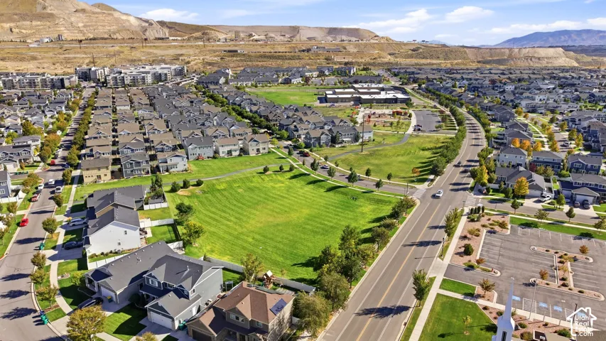 Residential community with varied architectural styles, extensive green spaces, and paved roadways