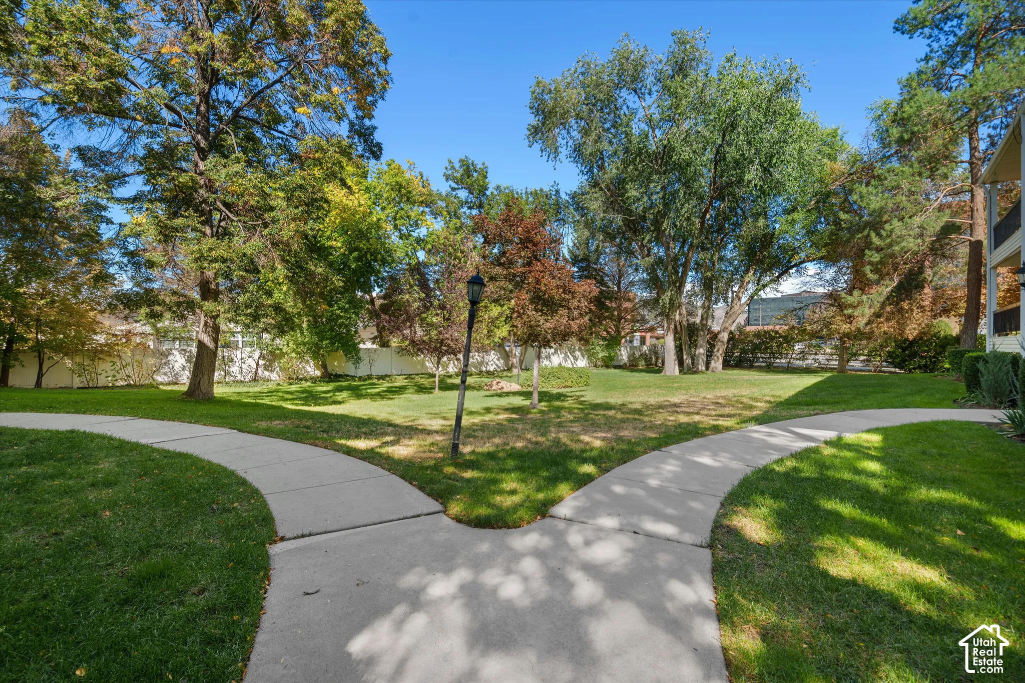 Manicured lawn with mature trees and paved walkways