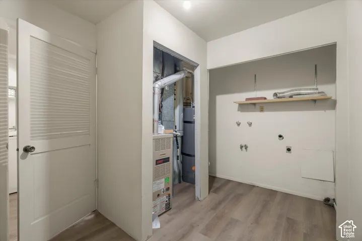 Utility closet featuring a furnace and water heater