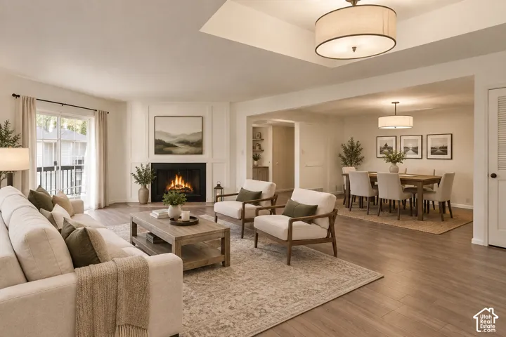 Built-in fireplace with surround, wood-finish flooring, recessed ceiling lighting, and a sliding glass door