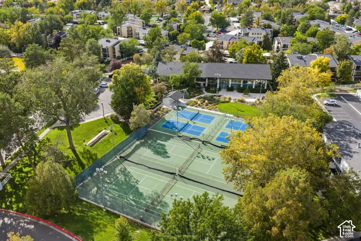 Two fenced tennis courts and two fenced pickleball courts