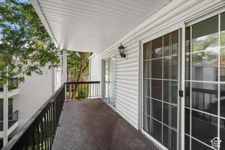 Private balcony featuring a black metal railing and textured flooring