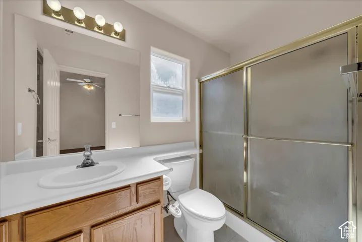 Spa-inspired bathroom featuring a wood-finish vanity with dual-sink configuration, white quartz countertop, and polished chrome fixtures