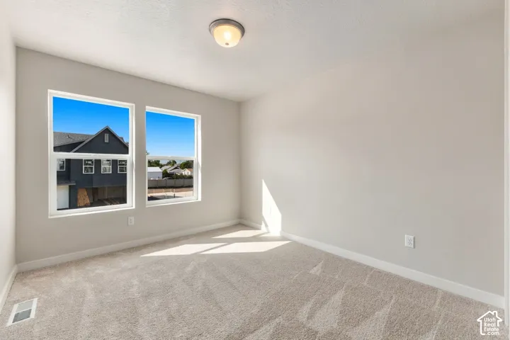 Neutral wall finishes, dual windows, and ceiling-mounted lighting