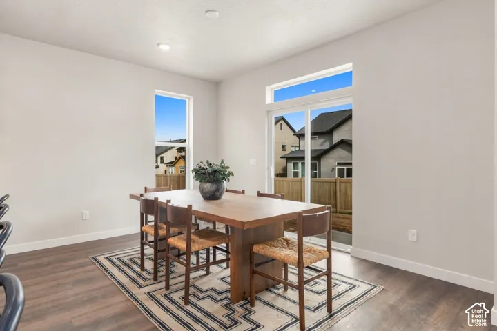 Wood-finish flooring, recessed lighting, and a sliding glass door providing outdoor access