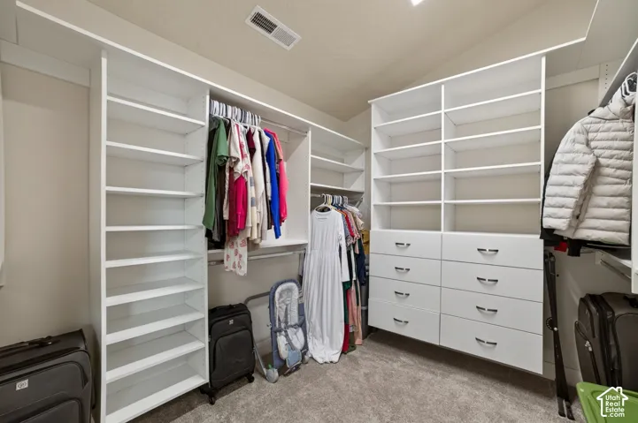 Custom built-in closet system with multiple shelving units, integrated drawers, and hanging rods