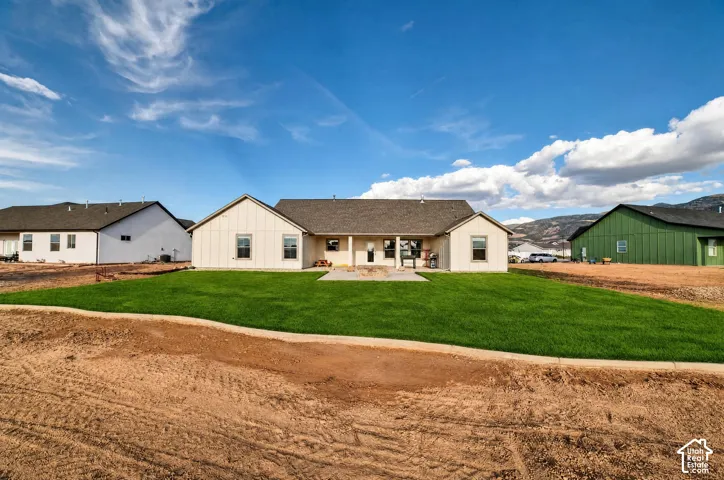 Newly constructed residence featuring a clean-lined architectural design with multiple gabled rooflines and neutral exterior finishes