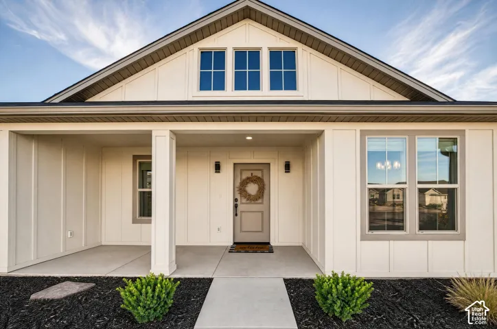 White board-and-batten siding exterior with a covered porch
