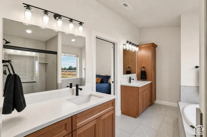 Dual vanity with integrated sinks, white countertops, wood-finish cabinetry, and matte black fixtures