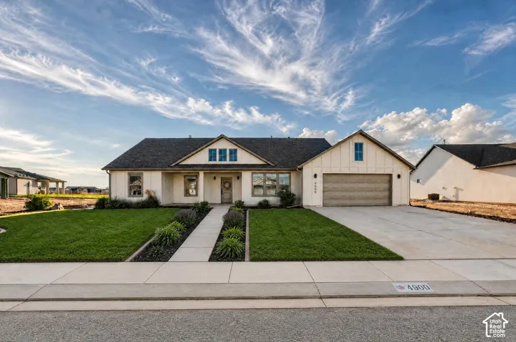 Ranch-style exterior with a dark-shingle roof