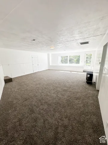 West living room with large windows and back door to the southside patio. Gas fireplace.