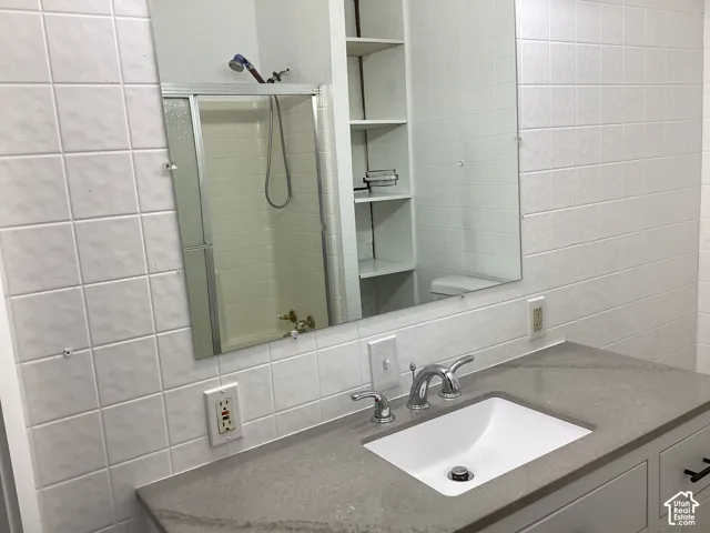 Vanity with a light gray countertop, undermount sink, and chrome faucet. Master bathroom.