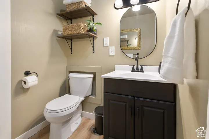 Vanity with white countertop, black cabinetry, and matte black faucet