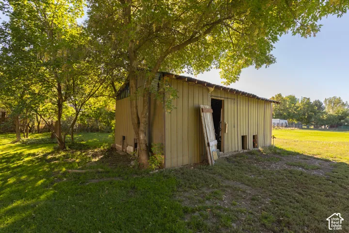 Outbuilding with vertical wood siding and a sloped roof