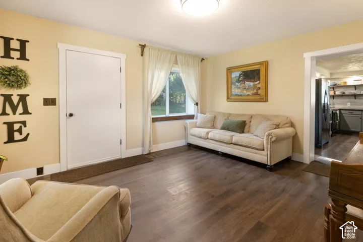 Wood-finish flooring, recessed lighting, and a white trim package